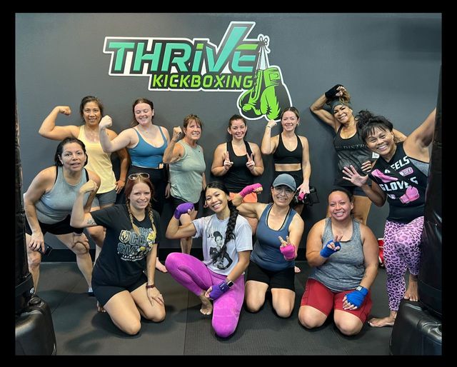 Group kickboxing class training at heavy bags